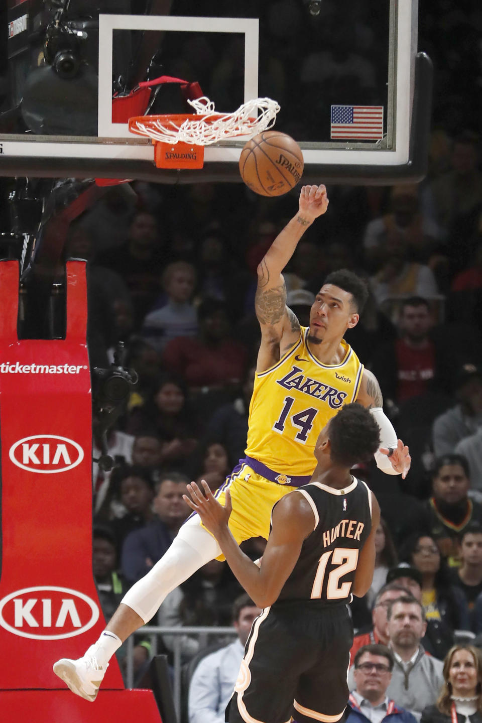Los Angeles Lakers guard Danny Green (14) scores against Atlanta Hawks forward De'Andre Hunter (12) in the first half of an NBA basketball game Sunday, Dec. 15, 2019, in Atlanta. (AP Photo/John Bazemore)