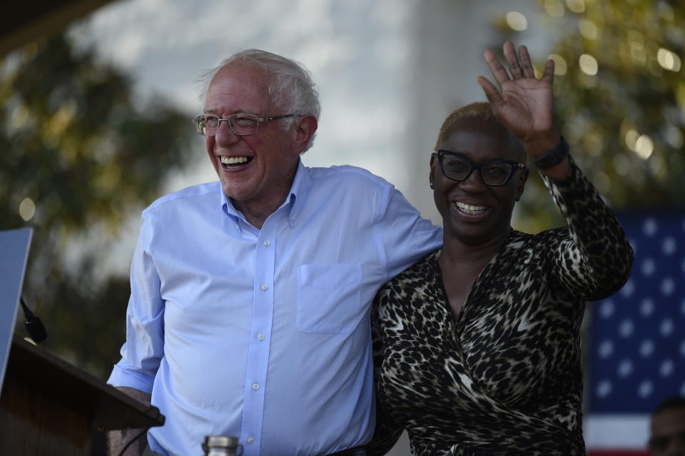 Democratic presidential contender Bernie Sanders smiles with Nina Turner, right, the national co-chair of his presidential campaign, at a Medicare for All town hall gathering on Friday, Aug. 30, 2019, in Florence, S.C. (AP Photo/Meg Kinnard)