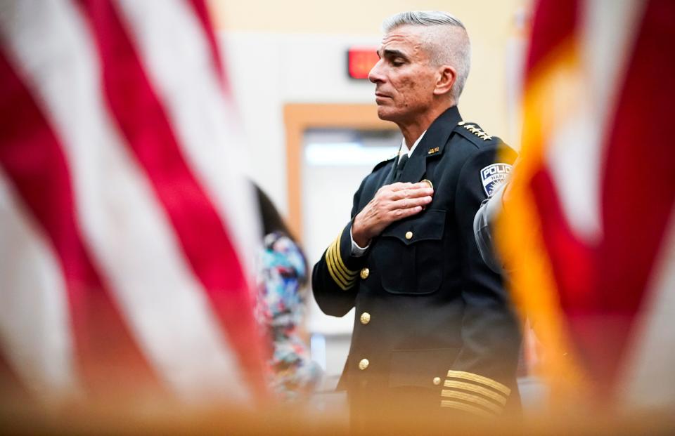 Naples Police Chief Ciro Dominguez closes his eyes as the national anthem is performed during a fallen officer memorial service hosted by the Collier County Sheriff’s Office at the Collier County South Regional Library in Naples on Wednesday, May 8, 2024.