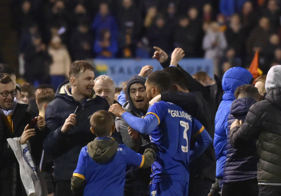 Shrewsbury's Scott Goldbourne, center, celebrates with fans at the end of the English FA Cup fourth round soccer match between Shrewsbury Town and Liverpool at the Montgomery Waters Meadow in Shrewsbury, England, Sunday, Jan. 26, 2020. (AP Photo/Rui Vieira)