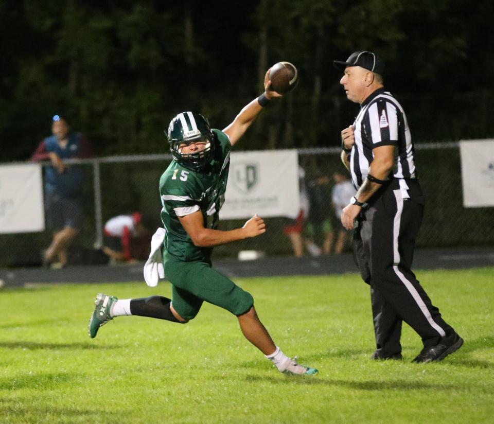 Dover quarterback Ryder Aubin celebrates his 2-yard touchdown run late in the second quarter of the Green Wave's season-opening 14-0 win over Winnacunnet