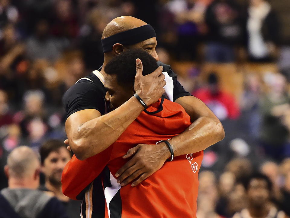 Atlanta Hawks guard Vince Carter hugs Toronto Raptors guard Kyle Lowry, after Lowry became the franchise leader in assists, during the second half of an NBA basketball game Tuesday, Jan. 28, 2020, in Toronto. (Frank Gunn/The Canadian Press via AP)