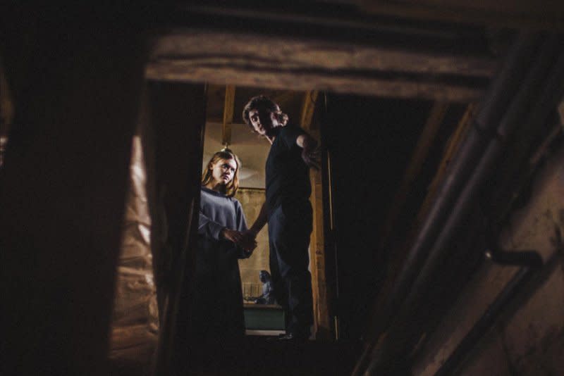 Anya (Holland Roden) and Emmett (Kyle Gallner) explore his mother's house. Photo courtesy of Dark Sky Films