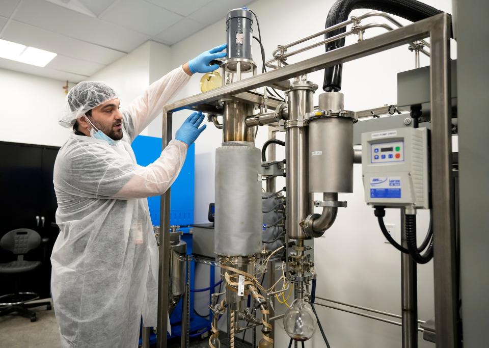 Processing manager Jordan Tipton explains technology in the refining room during a tour of PharmaCann's cultivation and processing facility at Buckeye Lake.