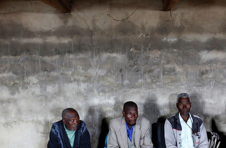 Former gold miners listen to speakers at a registration meeting for miners with silicosis in Bizana in South Africa's impoverished Eastern Cape province, March 7, 2012. REUTERS/Mike Hutchings/File Photo