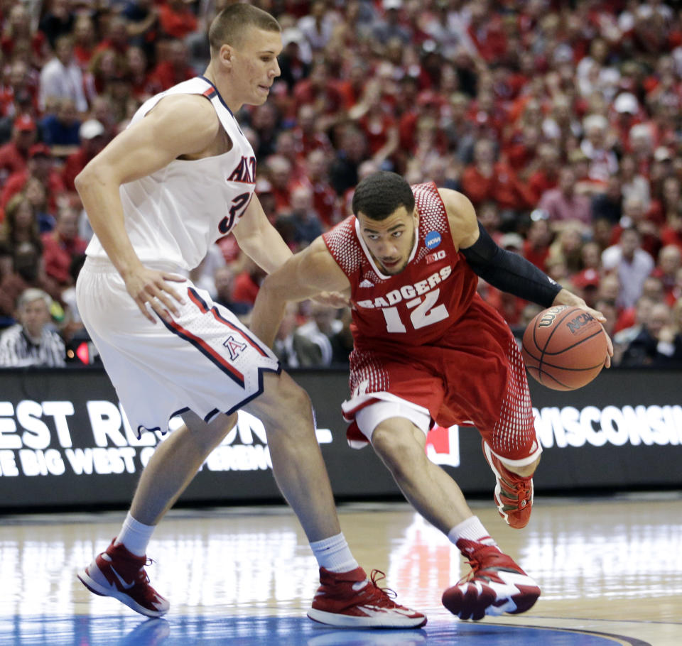 Wisconsin 's Traevon Jackson tries to drive past Arizona center Kaleb Tarczewski, left, during the first half in a regional final NCAA college basketball tournament game, Saturday, March 29, 2014, in Anaheim, Calif. (AP Photo/Jae C. Hong)