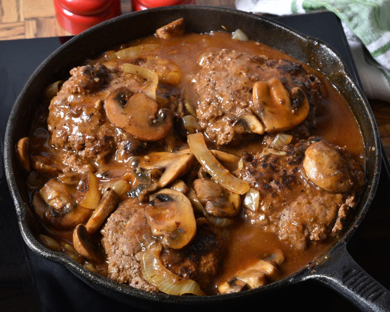 Salisbury steak with mushroom gravy in a cast iron skillet