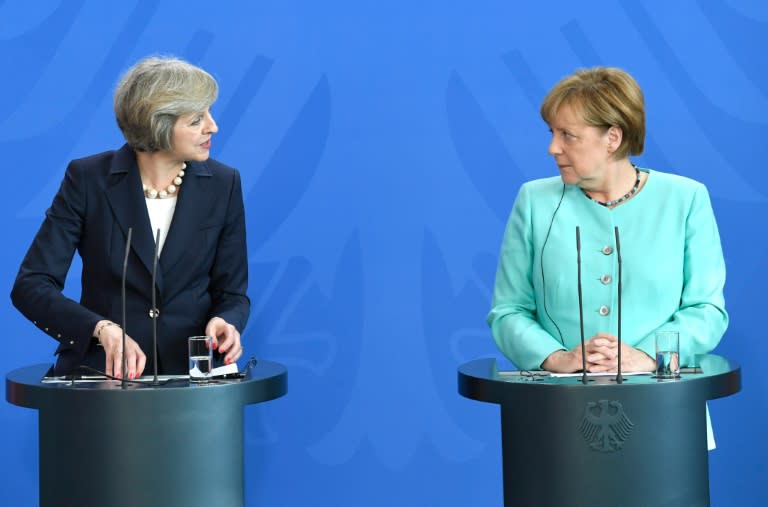 German Chancellor Angela Merkel (R) and British Prime Minister Theresa May attend a press conference after talks at the chancellery in Berlin on July 20, 2016