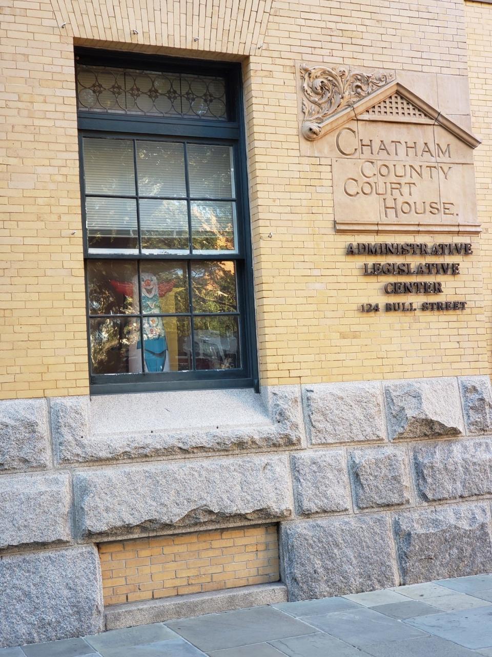 An inflatable clown can be seen from the Chatham County Court House window before the start of the LOST press conference. The blinds were later shuttered when the presser started.