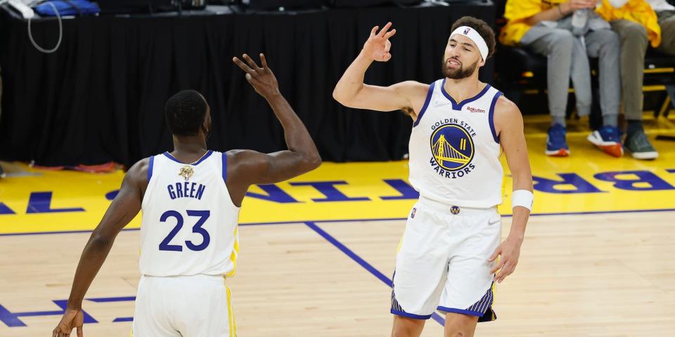 Draymond Green and Klay Thompson celebrate making a three-pointer.