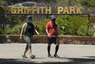 Hikers one of the trails near Griffith Park, Thursday, May 28, 2020, in Los Angeles. Several parks and trails have recently reopened in the city during the coronavirus pandemic. (AP Photo/Mark J. Terrill)