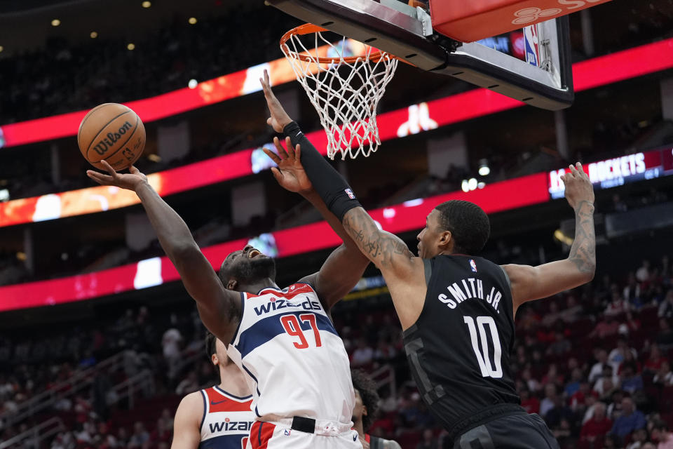 Washington Wizards' Eugene Omoruyi (97) goes up for a shot as Houston Rockets' Jabari Smith Jr. (10) defends during the first half of an NBA basketball game Thursday, March 14, 2024, in Houston. (AP Photo/David J. Phillip)