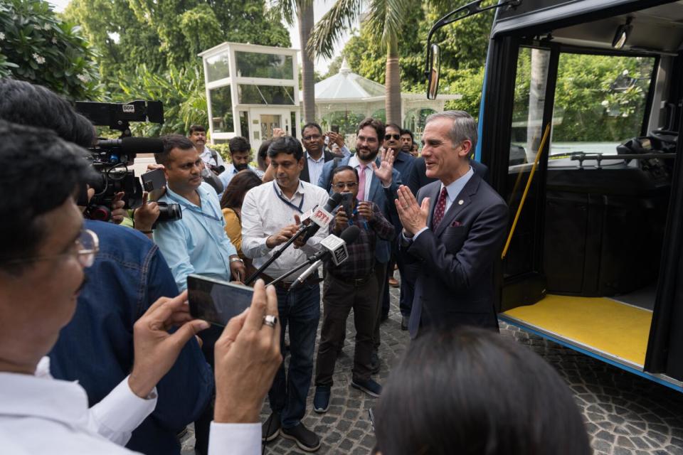 Garcetti talks with the local press after taking a ride in an electric bus in Delhi.