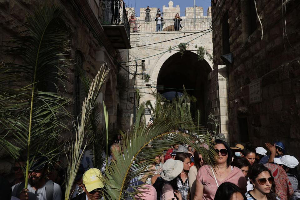 People take part in the Palm Sunday procession in Jerusalem on April 10, 2022. <a href="https://www.gettyimages.com/detail/news-photo/people-take-part-in-the-palm-sunday-procession-in-jerusalem-news-photo/1239896869?adppopup=true" rel="nofollow noopener" target="_blank" data-ylk="slk:Mostafa Alkharouf/Anadolu Agency via Getty Images;elm:context_link;itc:0;sec:content-canvas" class="link ">Mostafa Alkharouf/Anadolu Agency via Getty Images</a>