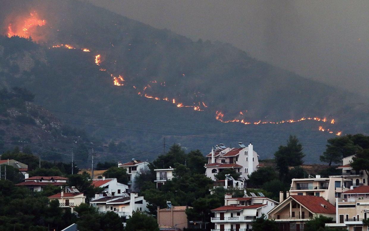 Fire approaches houses at Penteli mount, northeast Attica