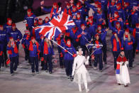 <p>Flag bearer Lizzy Yarnold of Great Britain leads the team, who all wear blue ski jackets, black pants, and red accessories during the opening ceremony of the 2018 PyeongChang Games. (Photo: Ronald Martinez/Getty Images) </p>