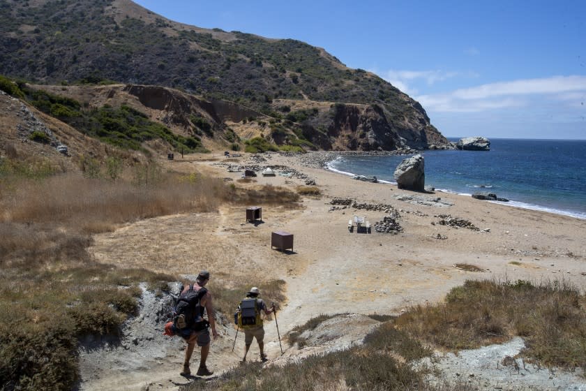 PARSONS LANDING, CA - AUGUST 11: Hikers Jeff Davis, left, of Anaheim, and Brendan Falagrady, of Irvine, arrive at Parsons Landing campground in Catalina Island on Tuesday, Aug. 11, 2020. (Allen J. Schaben / Los Angeles Times)