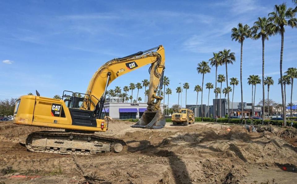 Heavy equipment operators grade the area that was the Macaroni Grill to make way for a new building at the corner of Blackstone and El Paso avenues in the River Park shopping center.
