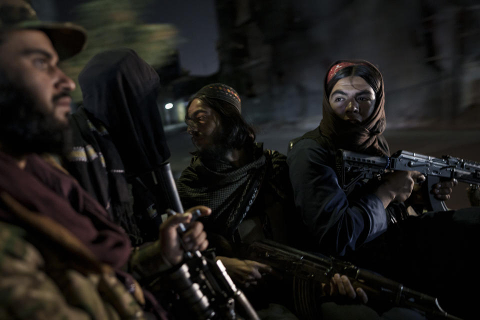 FILE - Taliban fighters ride in the back of a vehicle during a night patrol in Kabul, Afghanistan, on Sept. 12, 2021. On the night of Jan. 13, 2022, a Taliban security guard at a Kabul checkpoint opened fire on a car carrying a family home from a wedding, killing 25-year-old Zainab Abdullahi. The Taliban say it was a mix-up between guards. But Zainab’s death highlights one dilemma facing Afghanistan’s new rulers as they move from waging an insurgency to governing. (AP Photo/Felipe Dana, File)