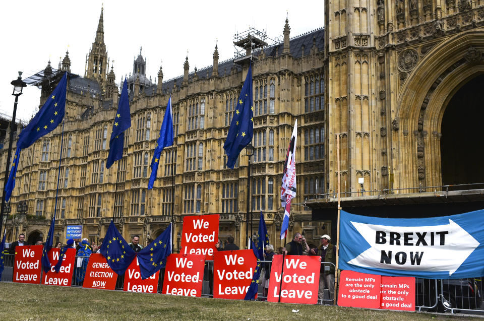 Pro Brexit placards and EU flags are pictured outside the Houses of Parliament, in London, Thursday, Sept. 5, 2019. Prime Minister Boris Johnson kept up his push Thursday for an early general election as a way to break Britain's Brexit impasse, as lawmakers moved to stop the U.K. leaving the European Union next month without a divorce deal. (AP Photo/Alberto Pezzali)