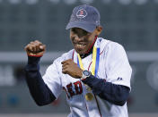 Meb Keflezighi, men's winner of this week's Boston Marathon, reacts after throwing a ceremonial first pitch prior to a baseball game between the Boston Red Sox and New York Yankees at Fenway Park in Boston, Wednesday, April 23, 2014. (AP Photo/Elise Amendola)