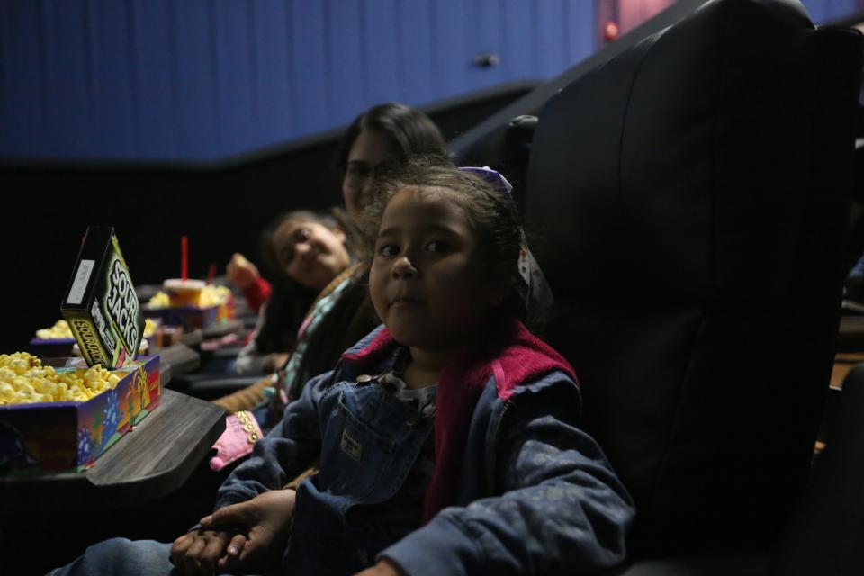 Cataleya Vasquez, 5, eats snacks as she prepares to watch a screening of "The Lion King" at the Las Cruces International Film Festival on March 4, 2022.