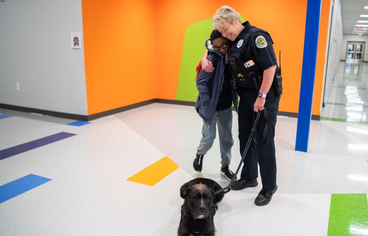 Cadence Thomas hugs Officer Faye Okert and greets Sgt. Bo in the morning before heading to class at Goodlettsville Elementary School in Goodlettsville, Tenn., Thursday, Jan. 25, 2024.