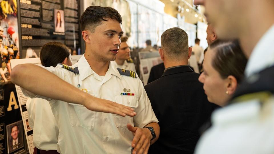 Cadet Ashton Gaines speaks with attendees at the research symposium. (Ty Trotter/West Point)