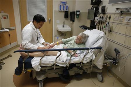 Patient Rose Bush receives treatment from Doctor Leon Yeh in the Emergency Room at OSF Saint Francis Medical Center in Peoria, Illinois, November 26, 2013. REUTERS/Jim Young