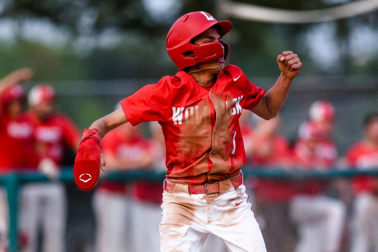 Laingsburg's Emilio Garcia celebrates after scoring against during the third inning on St. Johns Tuesday, May 23, 2023, at Kircher Municipal Park in Lansing.