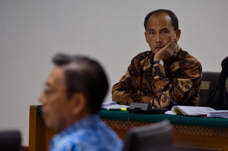 Indonesia's former central bank deputy governor Budi Mulya (right) listens as Vice President Boediono (left) testifies in court in Jakarta, on May 9, 2014
