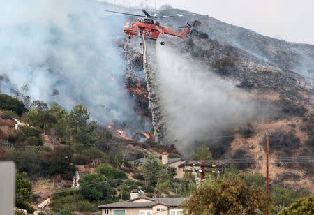 Water is dropped above homes in Sun Valley during the La Tuna Canyon fire over Burbank. REUTERS/ Kyle Grillot