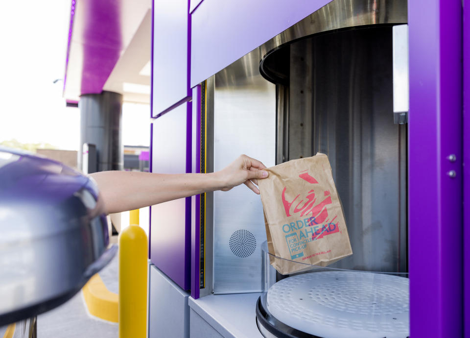 Customers at Taco Bell Defy pick up orders from a 