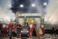 Kyle Larson, center right, is presented with his trophy in victory lane after winning a NASCAR Cup Series auto race at Bristol Motor Speedway Saturday, Sept. 18, 2021, in Bristol, Tenn. (AP Photo/Mark Humphrey)