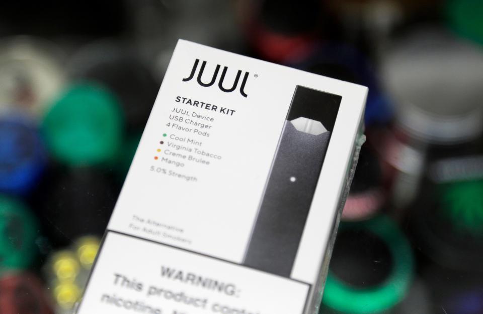 FILE - This Thursday, Dec. 20, 2018 file photo shows a Juul electronic cigarette starter kit at a smoke shop in New York. According to letters released on Friday, Feb. 8, 2019, the head of the Food and Drug Administration is questioning whether electronic cigarette maker Juul and its new partner Altria are following through on pledges to help reverse the current epidemic of underage vaping. (AP Photo/Seth Wenig)