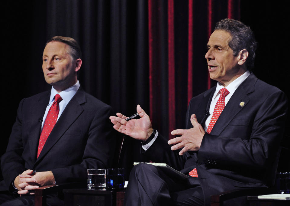 FILE — In this Oct. 22, 2014 file photo, New York State Republican gubernatorial candidate Rob Astorino, left, listens to the response of Democratic incumbent Andrew Cuomo, during a debate, in Buffalo , N.Y. New York’s attorney general has promised a thorough investigation of allegations that Cuomo sexually harassed at least two women. (AP Photo/Gary Wiepert, File)