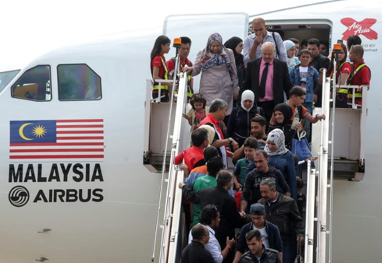 Syrian migrants arrive at Subang Air Force base in Subang, outside Kuala Lumpur on May 28, 2016