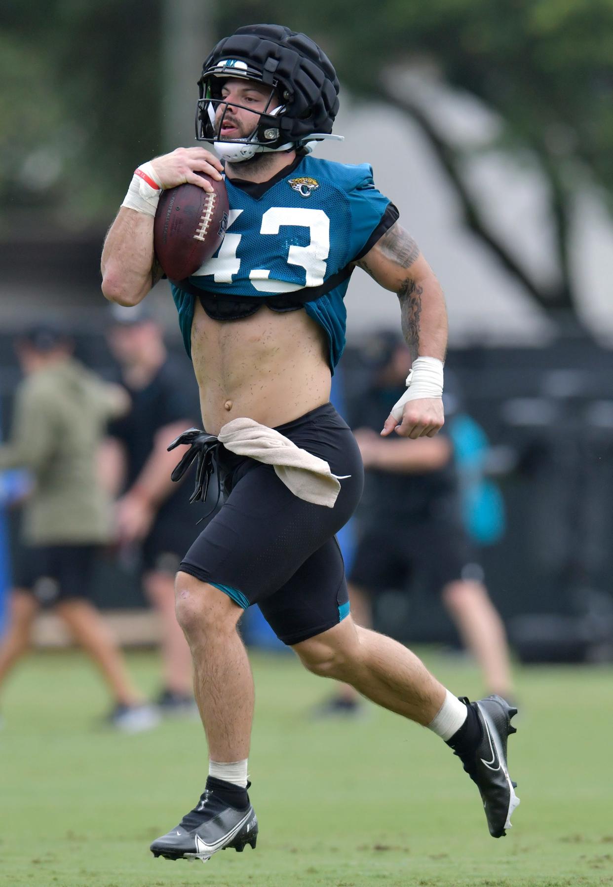 Jaguars fullback Derek Parish runs after a pass reception during a drill last week at training camp. Parish is attempting to make the team on offense after playing defensive line for the University of Houston.