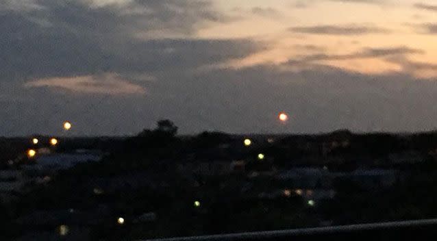 A cluster of bright red lights appeared “falling from the sky” above Ballina, Tuesday night. Source: Nimali Pathirana/Facebook