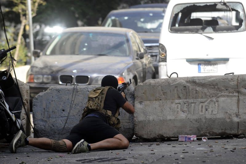 A Shiite fighter from Hezbollah and Amal movements takes aim with a Kalashnikov assault rifle amidst clashes in the area of Tayouneh in Oct. 2021 in the southern suburb of the capital Beirut. Israel and Hezbollah have been engaged in daily fighting, mostly restricted to parts of southern Lebanon and northern Israel, since the Lebanese militant group joined the battle a day after Hamas' Oct. 7 sneak attack on Israel sparked the war in the Gaza Strip. File Photo by Jamal Eddine/UPI