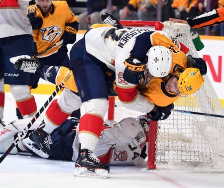 Jan 19, 2019; Nashville, TN, USA; Florida Panthers defenseman Ian McCoshen (12) slams Nashville Predators right wing Ryan Hartman (38) to the ice after the whistle during the third period at Bridgestone Arena. Mandatory Credit: Christopher Hanewinckel-USA TODAY Sports