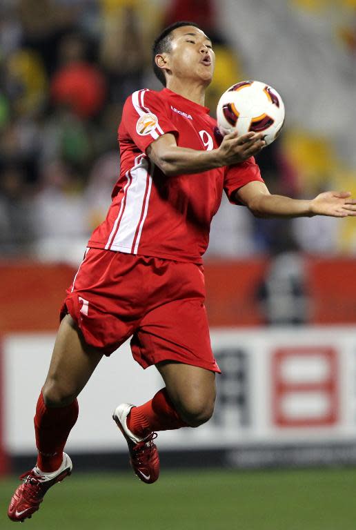 Jong Tae-Se jumps for the ball during North Korea's Asian Cup game against Iran in Doha on January 15, 2011