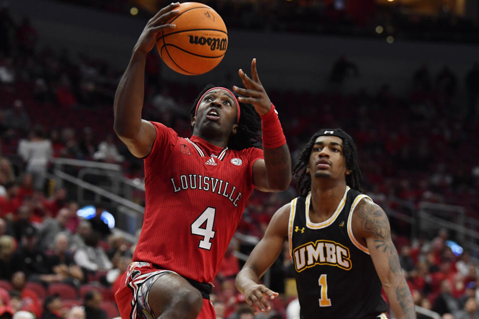 Louisville guard Ty-Laur Johnson (4) goes up for a layup past Maryland Baltimore County guard Ace Valentine (1) during the second half of an NCAA college basketball game in Louisville, Ky., Monday, Nov. 6, 2023. Louisville won 94-93. (AP Photo/Timothy D. Easley)