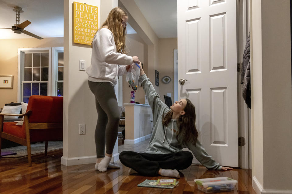 Kate and Sutton Bulkeley pack art materials ahead of a ski vacation, Friday, Feb. 16, 2024, in Westport, Conn. No longer just a distraction or a way to connect with friends, social media has matured into a physical space and a community that almost all U.S. teenagers belong to. Up to 95% of teenagers say they use social media, with more than one-third saying they are on it “almost constantly,” according to the Pew Research Center. (AP Photo/Julia Nikhinson)