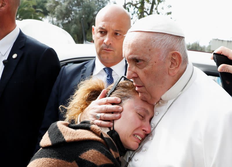 Pope Francis waves from a car as he leaves Rome's Gemelli hospital in Rome