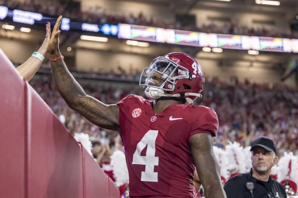 Alabama quarterback Jalen Milroe (4) high-fives a fan after scoring a touchdown against Middle Tennessee during the first half an NCAA college football game Saturday, Sept. 2, 2023, in Tuscaloosa, Ala. (AP Photo/Vasha Hunt)