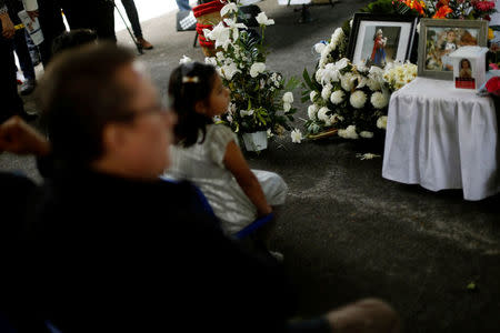 Family members and friends of children and grown-ups who died after their school collapsed in an earthquake, attend a mass, in Mexico City, Mexico September 24, 2017. REUTERS/Edgard Garrido