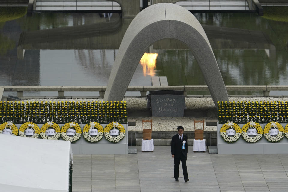 Japanese Prime Minister Shinzo Abe walks off after delivering a speech during a ceremony to mark the 75th anniversary of the bombing at the Hiroshima Peace Memorial Park Thursday, Aug. 6, 2020, in Hiroshima, western Japan. (AP Photo/Eugene Hoshiko)