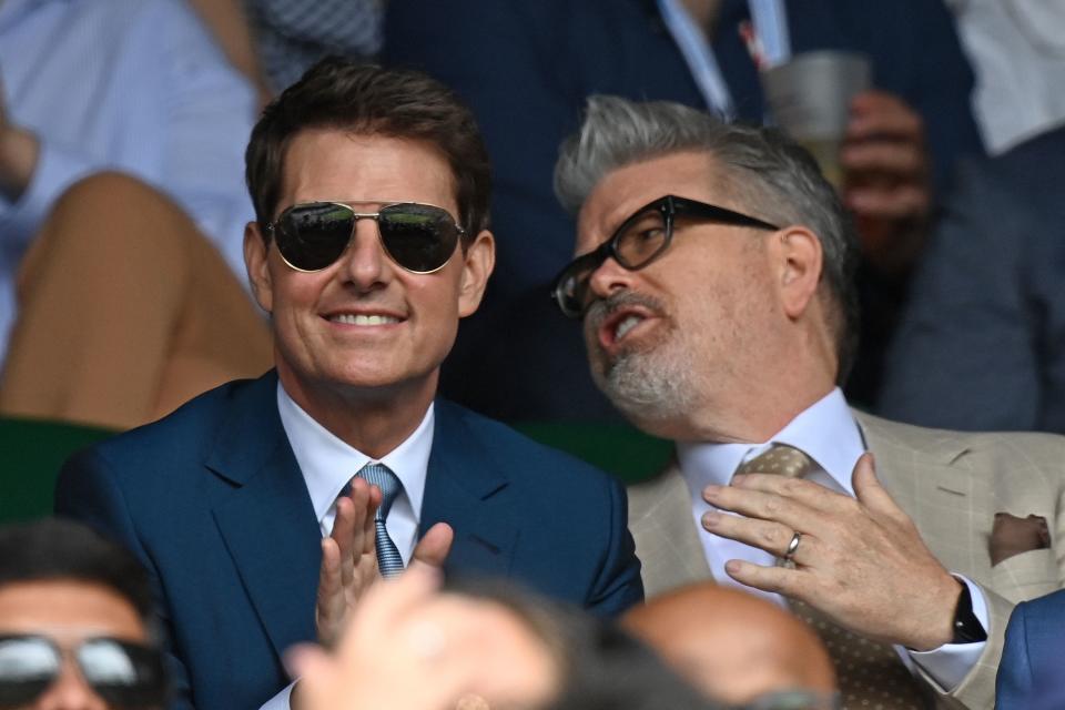 US actor Tom Cruise (L) sits in the Royal box on the thirteenth day of the 2021 Wimbledon Championships at The All England Tennis Club in Wimbledon, southwest London, on July 11, 2021. - RESTRICTED TO EDITORIAL USE (Photo by Glyn KIRK / AFP) / RESTRICTED TO EDITORIAL USE (Photo by GLYN KIRK/AFP via Getty Images)