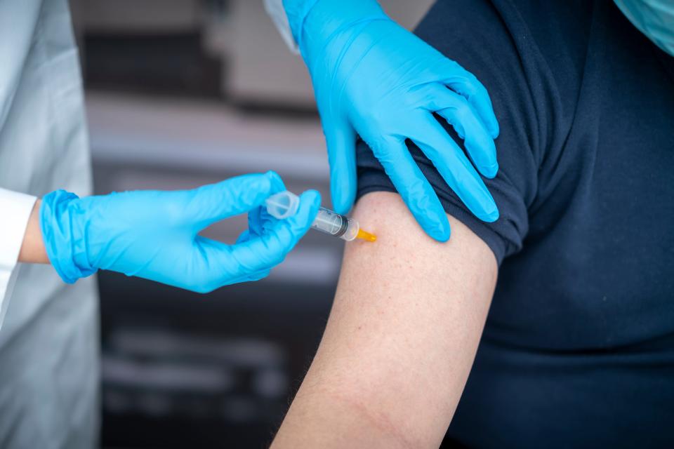 Man receives vaccine in arm